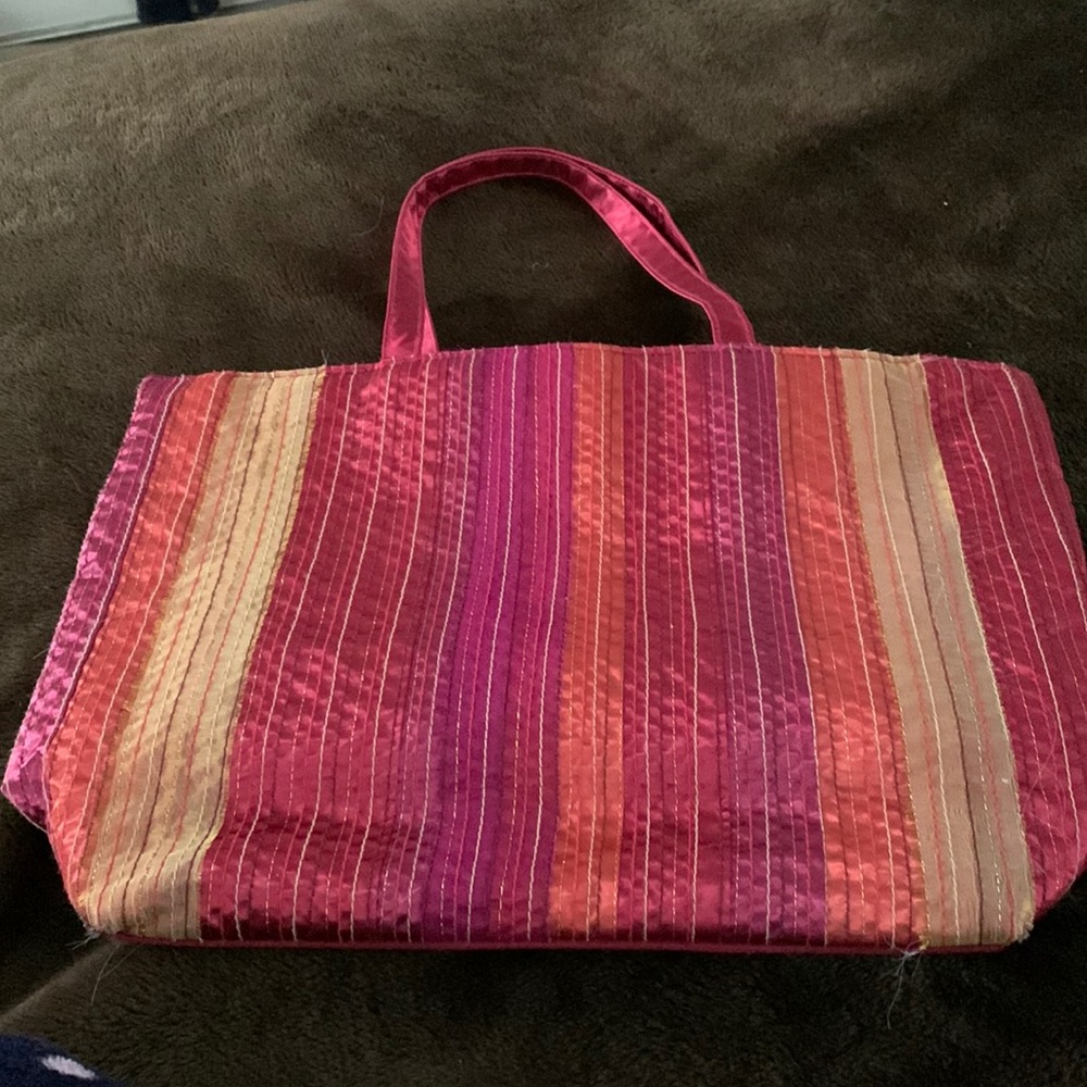 Ladies tote bag 16 1/2” x 11” with 9” handle interior has one large zipped area